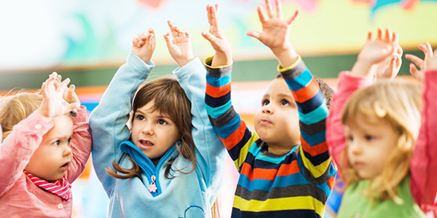 email header image - young children with hands raised