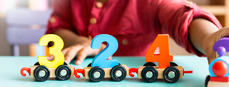 young children playing with numbers on wheels